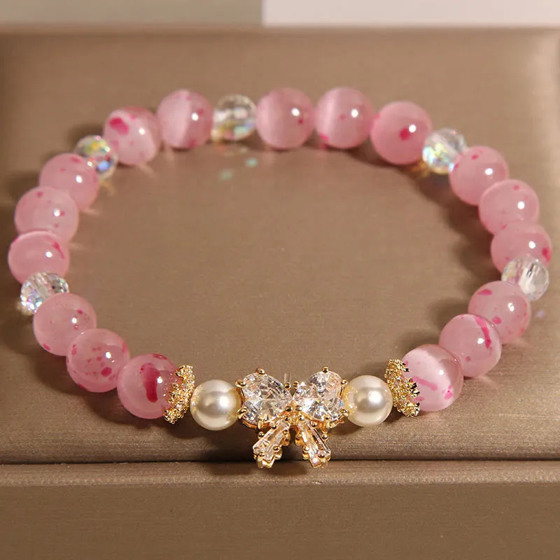 Bracelet de soutien en forme de nœud papillon avec perles œil de chat roses et fleurs de cerisier en Buddha Stones